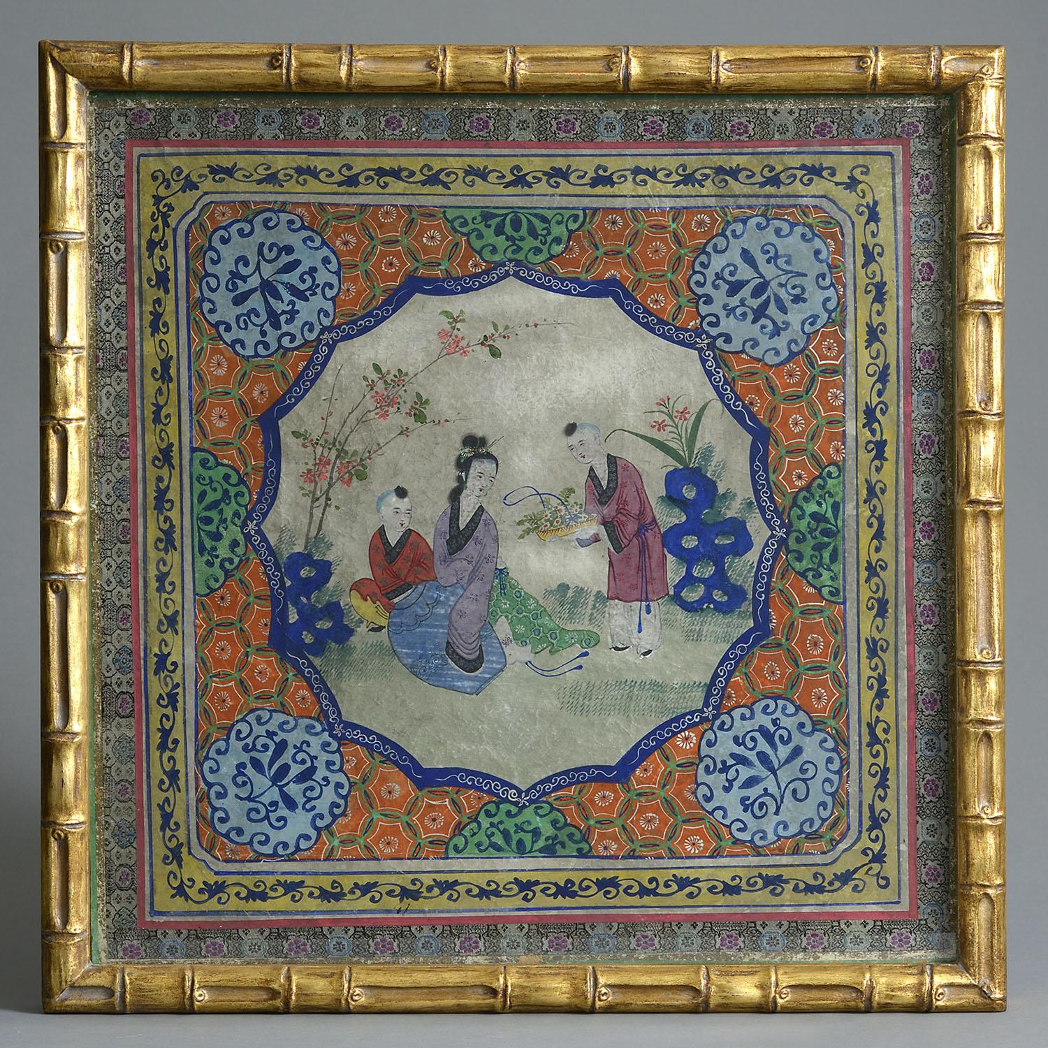 Framed Chinese silk painting of figures in a garden